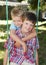 Two young boys on a swing