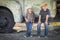 Two Young Boys Wearing Cowboy Hats Leaning Against Antique Truck