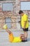 two young boys in yellow T-shirts are training. Training of abdominal muscles