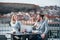 Two young business people sitting on a terrace outside office, having lunch break.