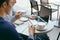 Two young businessmen are chatting in a coffee shop. - Image