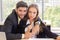 Two young businessmen, men and women, work at the office with a tablet and accompanying documents on the desk with smiles and