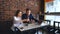 Two Young Businesspeople Working On Laptop In Coffee Shop