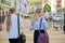 Two young businesswomen, office workers walking with backs