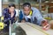 Two young carpenters working in shop