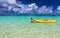 Two young caucasian boys kayaking at tropical sea on yellow kayak