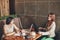 Two young caucasian businesswomen with laptop, notebook. Women in cafe