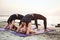 Two young caucasian females practicing yoga on beach