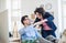 Two young cheerful businesspeople in a modern office, making fist bump.