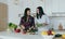 Two young cheerful girlfriends cooking salad home kitchen