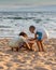 Two Young Children Building a Sandcastle on a Beach in Thailand