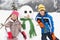 Two Young Children Building Snowman On Ski Holiday