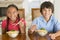 Two young children eating Chinese food