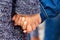 Two young children are holding hands. Girl holds brother by hand_