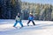 Two young children, siblings brothers, skiing in Austrian mountains on a sunny day