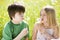 Two young children sitting outdoors