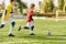 Two young children, wearing colorful soccer