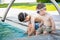 Two Young Chinese Caucasian Brothers By the Pool Wearing Swimming Goggles