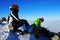 Two young climbers resting on top of Peleaga peak, Romania