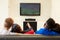 Two Young Couples Watching Television At Home Together