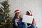 Two young cute asia women holding credit card while shopping online by aptop computer with happiness, Christmas holiday shopping