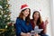 Two young cute asia women holding tablet and credit card while shopping online with happiness, Christmas holiday shopping concept