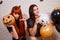 Two young cute women with pumpkin and painted balloons frighten