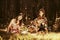 Two young fashion girls with fruit baskets in summer forest