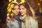 Two young fashion girls in white shirt and scarf in autumn park