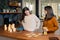 Two young femaies laying out deck of tarot cards in a kitchen