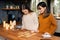 Two young femaies worried about meaning of tarot cards played in a kitchen