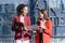 Two young female accountants walk and talk in front of the building\'s office.