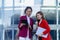 Two young female accountants walk and talk in front of the building\\\'s office.