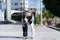 Two young female accountants walk and talk in front of the building\\\'s office.