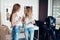 Two young female bloggers recording makeup tutorial on camera in beauty shop