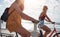 Two young female cycling outdoors on a sunny day