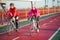 Two Young Female Cyclists Riding Road Bicycles on Bridge Bike Line in Cold Sunny Autumn Day. Healthy Lifestyle Concept.