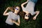 Two young female girl friends in sunglasses laying on the grass in park. Trendy Hipster Best friends Girls Relaxing. Summer