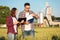 Two young female and male agronomists or farmers inspecting wheat fields before the harvest