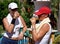 Two young, fit, healthy, tanned women having a drink after a hot game of tennis