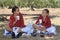 Two young flamenco dancers have a picnic in an olive grove in the typical flamenco costume