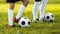 Two young football players training on a grass field. Boys in a sportswear