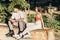 Two young friends drinking soft drinks while sitting wearing inline skates