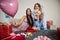 Two young girlfriends sitting on the bed