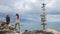 Two young girls argue and choosing which way they should go. wooden sign post arrows pointing to various cities and