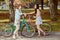 The two young girls with bicycles in park