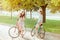 The two young girls with bicycles in park