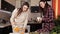 Two young girls chatting in the kitchen while cooking dinner. Community, friends, food