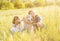 Two young girls cuddling retriever dog outdoors