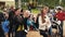 Two young girls dance in park on summer festival. People. Applaud. Smile